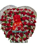 beautifull arrangment flowers with a toy 